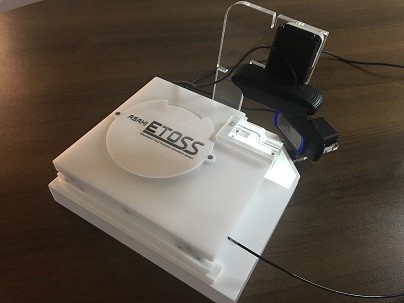 pic of 2 white base plates with a circular plate on the top with the ETOSS logo on it long with two HD web cameras attached to it