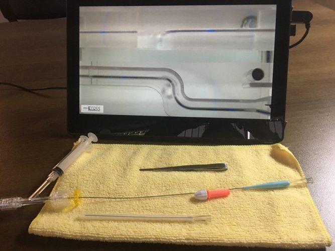pic of laptop monitor with yellow towel in front of it and guidewire setup on the towel